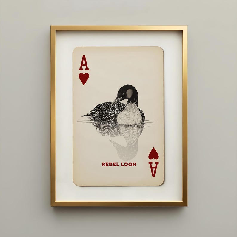 Vintage Rebel Loon art print featuring a black-and-cream common loon illustrated as the ace of hearts on an aged playing card, displayed in a slim gallery gold frame.