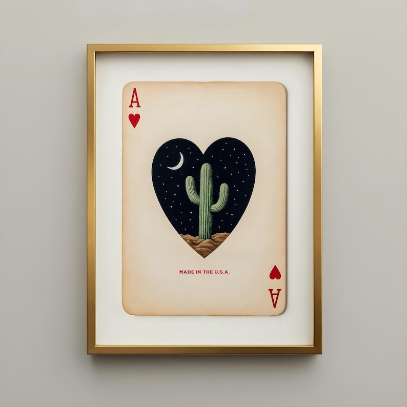 Framed art print of the Ace of Hearts playing card. The card features a heart-shaped cutout revealing a desert scene with a saguaro cactus, moon, and stars. The text "MADE IN THE U.S.A." is printed at the bottom. Cool apartment decor. Trendy wall art.