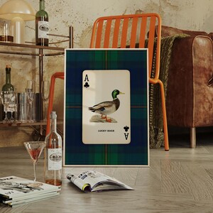 Mallard duck illustration on vintage ace of clubs playing card with green and blue plaid background, rustic preppy style