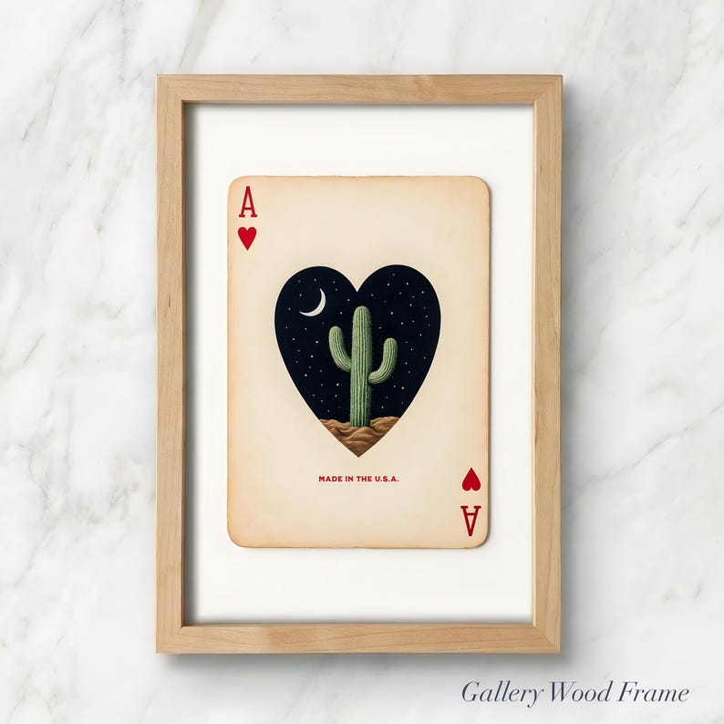 May include: A framed art print of the Ace of Hearts playing card. The card features a heart-shaped design with a cactus under a crescent moon and starry night sky. The text "MADE IN THE U.S.A." is printed at the bottom.
