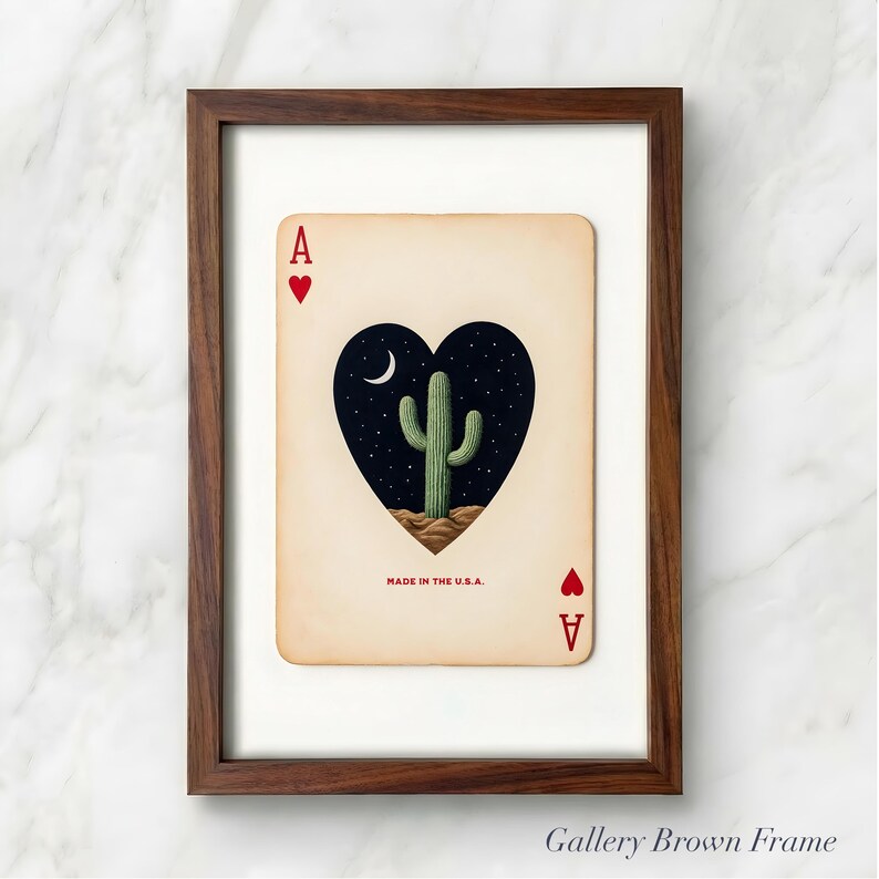 May include: A framed playing card featuring the Ace of Hearts. The card's heart shape contains a desert cactus under a starry night sky and a crescent moon. The text "MADE IN THE U.S.A." is printed at the bottom.