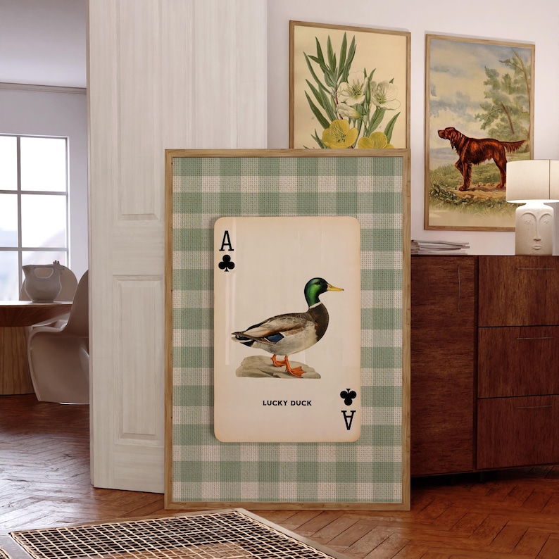 May include: A rectangular wall art print featuring a light green and white gingham background. Centered is a large playing card graphic with an Ace of Clubs symbol, a detailed illustration of a mallard duck, and the text LUCKY DUCK.