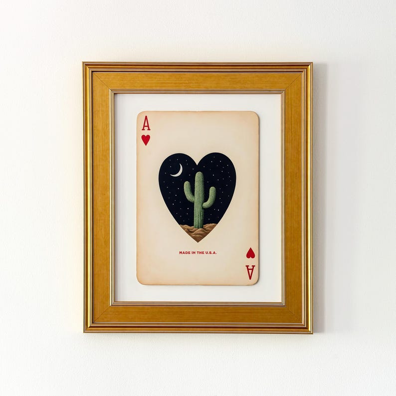 May include: Framed art print of the Ace of Hearts playing card. The card features a heart-shaped design with a cactus under a crescent moon and stars. The text "MADE IN THE U.S.A." is printed at the bottom.