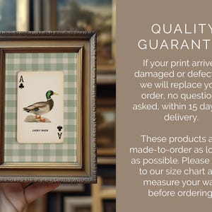 May include: A framed print showing an Ace of Clubs playing card with a duck illustration. The card is set against a green and white checked background, within a gold-toned frame. The text "LUCKY DUCK" is visible.