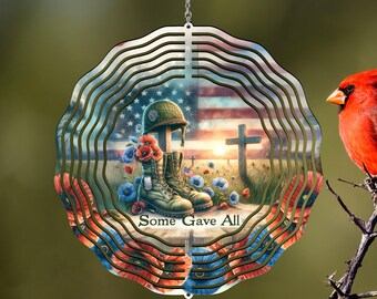 May include: A metal wind spinner with a patriotic design featuring an American flag, a soldier's boots, a cross, and poppies. The text "Some Gave All" is printed on the spinner.
