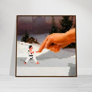 May include: A framed pixelated art print depicts a karate practitioner in a white uniform facing a giant pixelated hand. The background shows a snowy landscape with evergreen trees. The artwork has a brown frame.