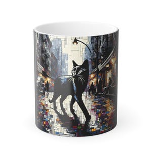 May include: White ceramic mug with a black cat illustration walking on a city street. The mug's design shows a street scene with buildings, a street lamp, and colourful reflections. The cat is the central element of the design.