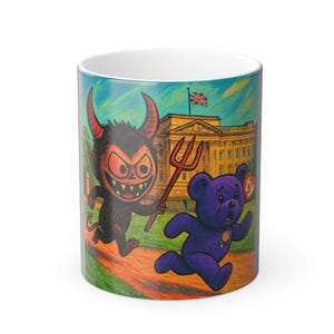 May include: A white ceramic mug featuring a cartoon illustration of a devil chasing a purple teddy bear in front of Buckingham Palace. The devil is holding a pitchfork. The teddy bear is holding a gold coin.
