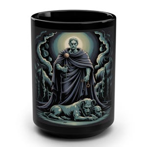 May include: Black ceramic mug with a detailed illustration of a robed figure holding a sword and key, with a dog and two skulls at the base. The artwork is in shades of blue, green, and grey, set against a dark background.