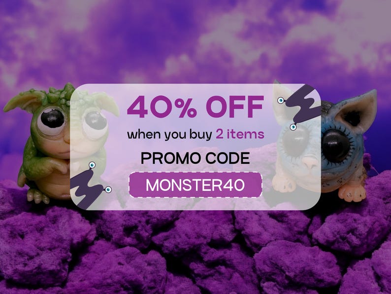 May include: A pink and white discount coupon with the text "40% OFF when you buy 2 items PROMO CODE MONSTER40". Two small, colourful, handmade creatures are on either side of the coupon.
