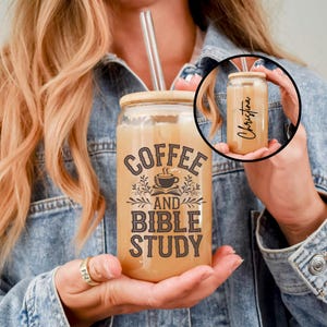 May include: A clear glass can with a brown wooden lid and a glass straw. The can has a black graphic that says "Coffee and Bible Study".