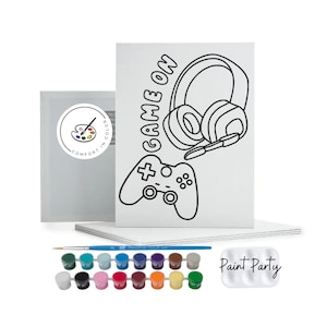 May include: A paint-by-numbers kit featuring a black and white outline of a video game controller and headphones with the text "Game On". The kit includes a set of acrylic paints, a paintbrush, and a canvas.