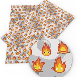 May include: A sheet of white fabric with a repeating pattern of orange flames with faces. The flames are on a gray background with a white swirl pattern.