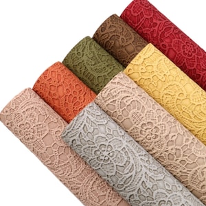 May include: A set of six rolls of faux leather with a lace pattern. The rolls are in various colours, including beige, grey, orange, green, brown, and red.