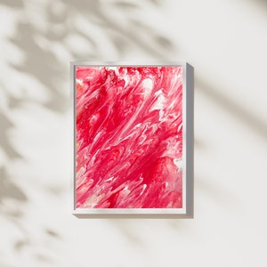 May include: Abstract painting in a white frame with a red and white swirling pattern.