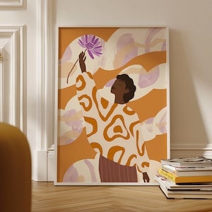 以下が含まれることがあります： 白い枠で囲まれたイラスト。肌の色が茶色の人のイラストで、白とオレンジの模様のシャツを着て、紫色の花に触れようとしている。背景は薄いオレンジ色で、白と紫の抽象的な形が描かれている。