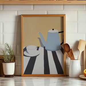 May include: A framed illustration of a blue teapot and a white teacup on a black and white striped tablecloth. The teapot has a black handle and spout. The teacup is sitting on a white saucer.