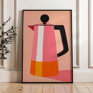 May include: A pink and orange coffee pot with a black handle and lid against a light pink background.