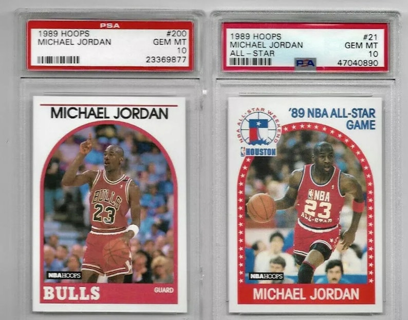 May include: Two graded trading cards of Michael Jordan from the 1989 Hoops series. The card on the left shows Jordan in his Chicago Bulls uniform, while the card on the right shows him in his 1989 NBA All-Star Game uniform. Both cards are graded Gem Mint 10 by PSA.