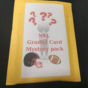 May include: A yellow envelope with a white label. The label has a cartoon character with a question mark above its head. The text on the label reads "NFL Graded Card Mystery Pack". There is a football helmet and a football on the label.