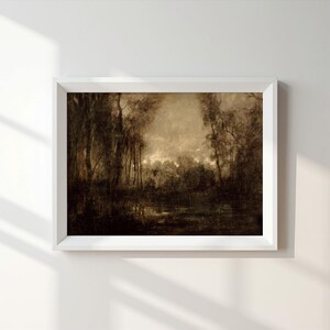May include: A rectangular wall art print in a white frame featuring a sepia-toned landscape painting of a dense forest with tall trees and a dark, reflective body of water at the base, set against a light, hazy sky in the upper center portion.