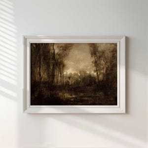 May include: A framed landscape painting in sepia tones depicting a dense forest with tall trees and a dark, reflective body of water in the foreground. The artwork is enclosed in a simple, white rectangular frame with a clean, molded edge profile.