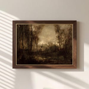 May include: A framed landscape painting featuring a dark, moody forest scene with tall trees and a reflective body of water. The artwork uses a monochromatic sepia and brown color palette, encased in a dark wood frame with a thin gold inner border.
