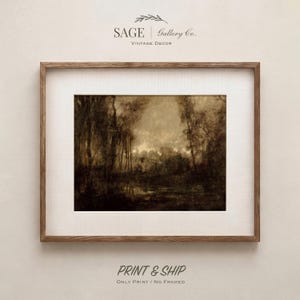 May include: A framed landscape print featuring a dark, moody forest scene with tall trees and a reflective body of water in sepia tones. The artwork is encased in a simple wooden frame with a wide, textured off-white matting border.