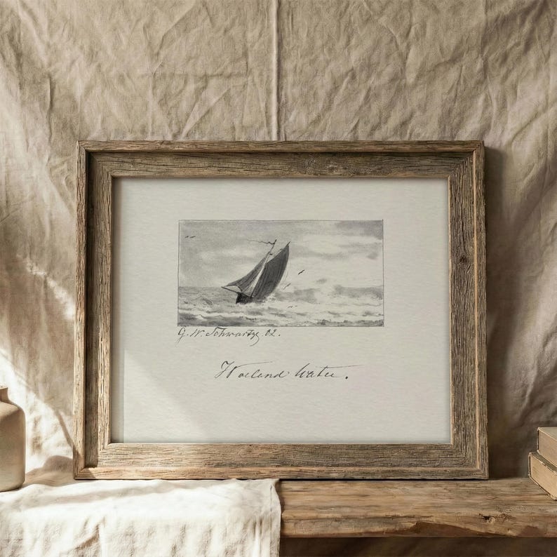 May include: A framed monochrome print of a sailboat at sea. The artwork is in a wooden frame. The image shows a sailing boat on rough water. The print includes the text "Holland water."