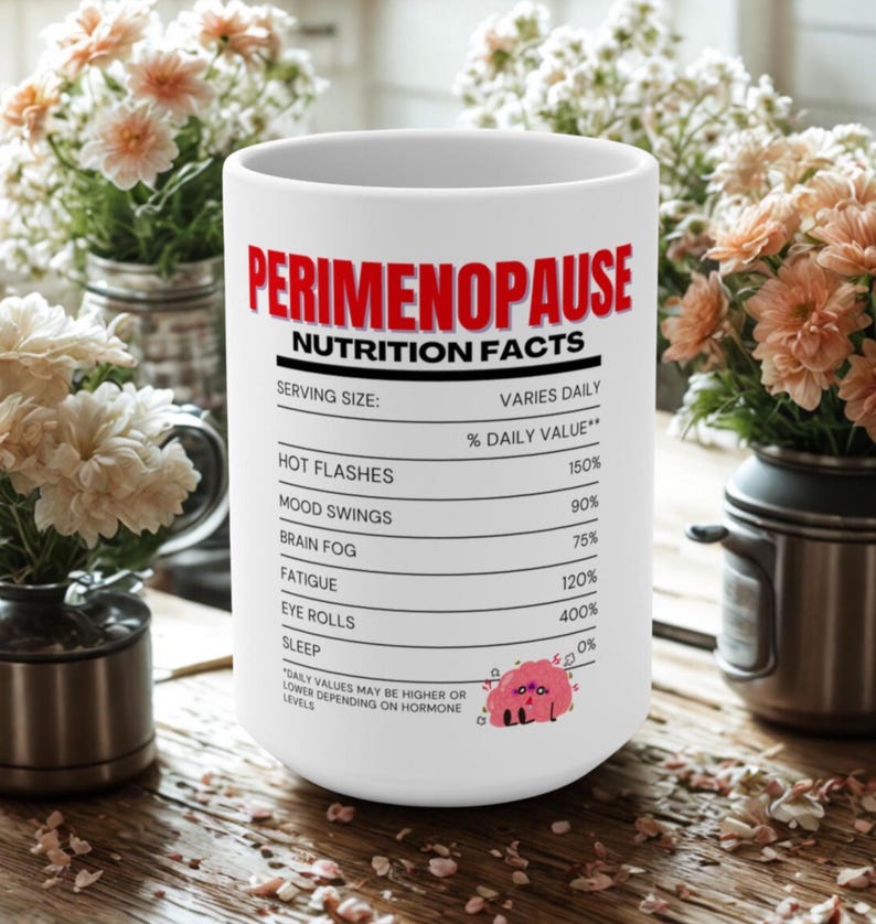 May include: White ceramic mug with the text "PERIMENOPAUSE NUTRITION FACTS" in red and black. The mug lists various symptoms and percentages, including hot flashes, mood swings, and fatigue. A cartoon brain graphic is also present.