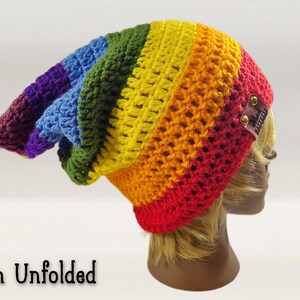 Image reads "brim unfolded" - this fun pointed beanie is shown from the side with its brim unfolded showing its long length and pixie shaped back part. Beanie can be adjusted to any height, slouch length, you can change the colors, the style, even change the brim type from foldable to ribbed.  make this beanie fit your style!  make general customizations free of charge!  Add pom poms, hand made embroidered patches, tassels, buttons, add your name, anything you want for your very own custom hat.