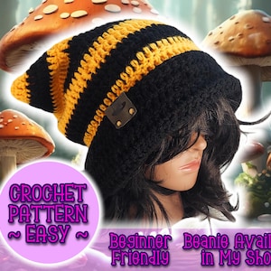 Puede incluir: Un gorro de ganchillo a rayas negras y amarillas con una etiqueta de cuero. El gorro se muestra en una cabeza de maniquí, rodeado de decoraciones de setas. La imagen incluye el texto "Crochet Pattern ~ Easy ~ Beginner Friendly Beanie Available in My Shop!"