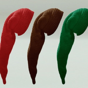 May include: Three long, pointed hats made of crocheted yarn in solid red, brown, and green colours. Each hat features a wide, folded brim and a long, tapering tail that curves downward, showcasing a consistent textured stitch pattern throughout.