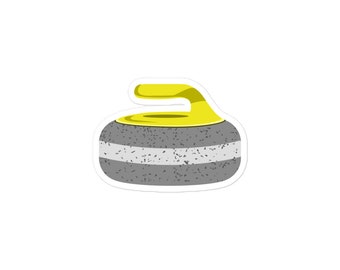 May include: A gray curling stone with a yellow handle. The stone has a white stripe around the middle.