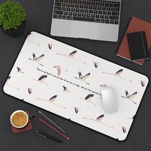 May include: A rectangular mousepad with a white background featuring a pattern of pink and navy blue flamingos in flight. The mousepad has a black border and includes the text "Look at the birds of the air: they do not sow or reap... and yet your heavenly Fa".