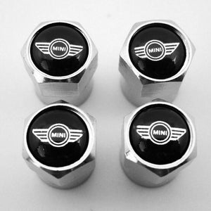 May include: Four silver tyre valve stem caps with a black centre featuring the MINI logo in white.