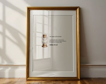 May include: A framed print with a gold frame and a white background. The print features a vintage illustration of a lantern with the text "The Light of The World" and the Bible verse "I am the light of the world: he that followeth me shall not walk in darkness, but shall have the light of life." John 8:12.