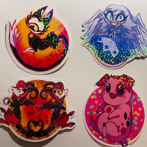 May include: Four holographic stickers featuring cartoon characters. The first sticker is a red and black cat with a yellow eye on a red background with hearts. The second sticker is a white angel with a blue dress and wings on a blue background with white dots. The third sticker is two red and black demons with horns and wings on a red background with hearts. The fourth sticker is a pink pig with a pink nose and black eyes on a pink background with colorful dots.