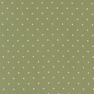 May include: Close-up of a green fabric with a repeating pattern of small, evenly spaced white polka dots. The fabric has a slightly textured appearance, and the dots are consistent in size and shape. The overall aesthetic is simple and classic.
