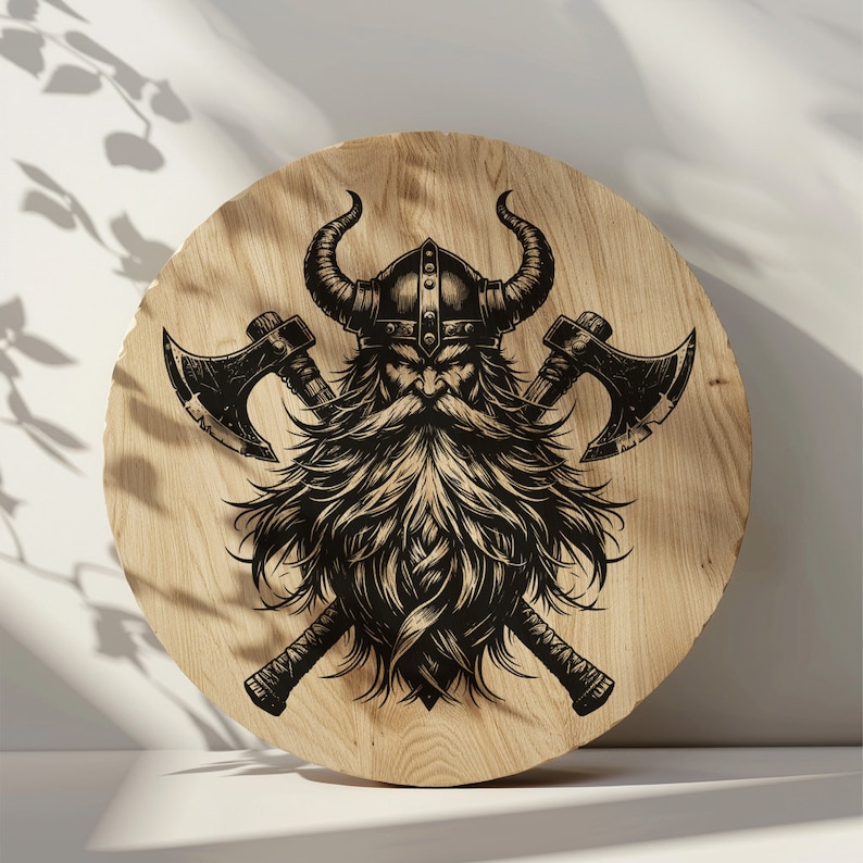 May include: A round wooden plaque with a black and white illustration of a Viking warrior with a beard and crossed axes. The warrior is wearing a horned helmet.