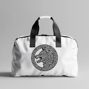 May include: White canvas duffel bag with black handles and a black and white graphic of a wolf's head in a Celtic knot design.