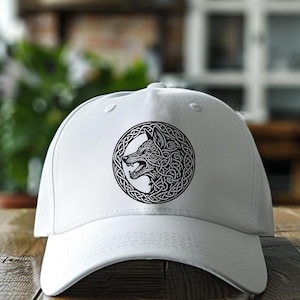 May include: White baseball cap with a black and white wolf head design in a Celtic knot pattern.