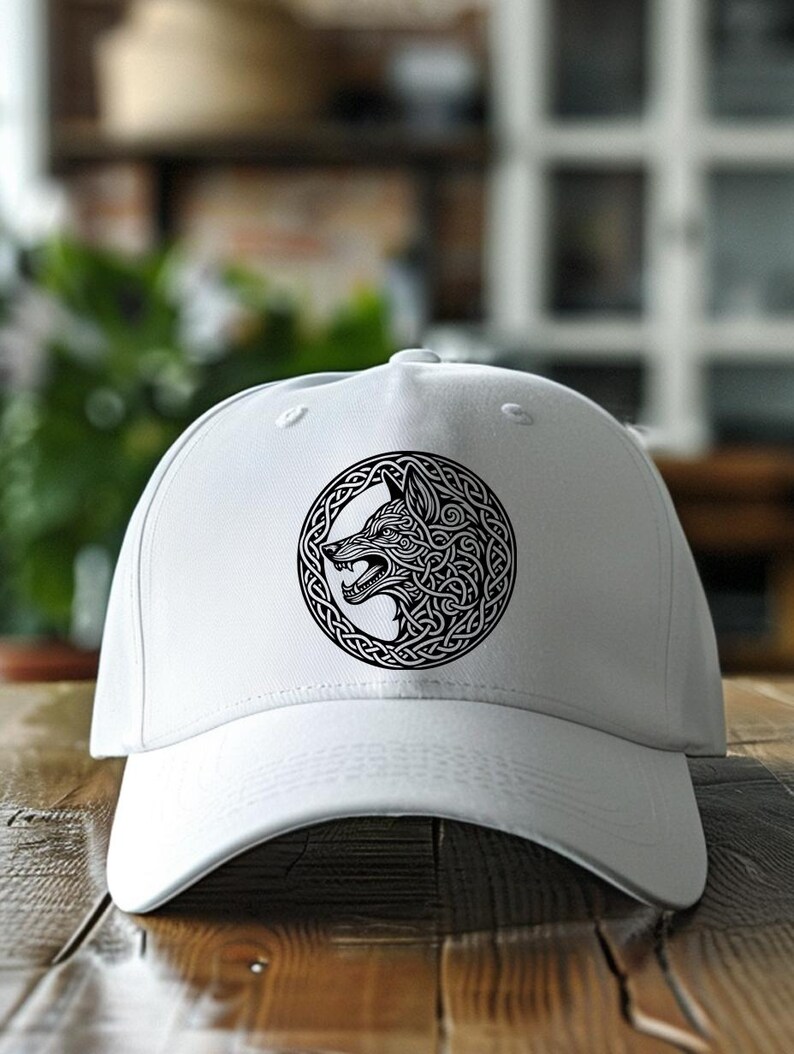 May include: White baseball cap with a black and white wolf head design in a Celtic knot pattern.