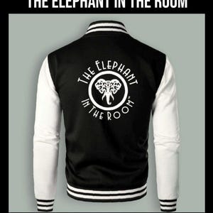 May include: Black and white varsity jacket with white sleeves and a white circle on the back with the text "THE ELEPHANT IN THE ROOM" and an elephant graphic inside the circle.