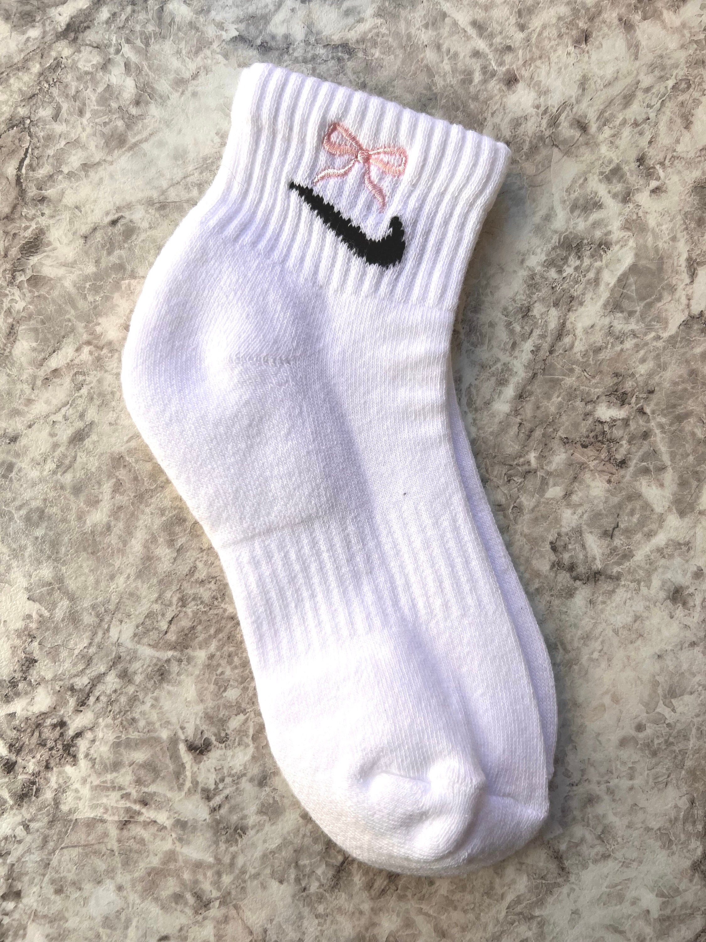 white nike socks with pink logo