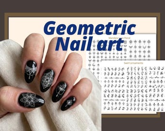 May include: Black fingernails decorated with intricate white mandala and floral line art decals. Two rectangular sticker sheets are visible in the background, featuring rows of black mandala, lace, floral, and swirl ornament designs on white paper.