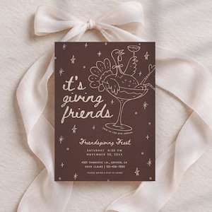 Printable Friendsgiving invitation styled on softly draped ivory fabric with warm natural shadows and a coordinating scalloped cream paper detail. The dark brown card features delicate blush pink line art of a festive cocktail glass with bows, scattered stars, and hand-lettered “it's giving friends” text. This whimsical Thanksgiving dinner invitation combines modern retro styling with a playful fall color palette and is fully editable in Canva, including all invitation wording and colors.