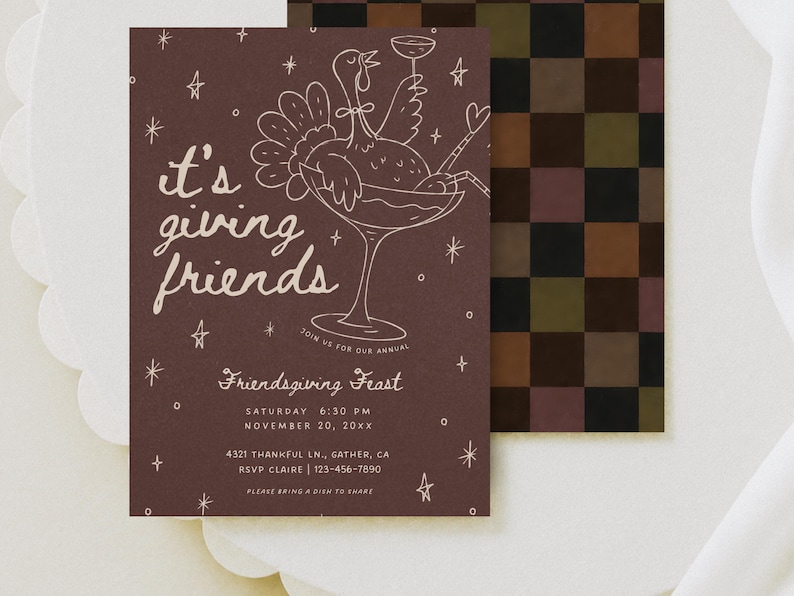 Printable Friendsgiving invitation styled on softly draped ivory fabric with warm natural shadows and a coordinating scalloped cream paper detail. The dark brown card features delicate blush pink line art of a festive cocktail glass with bows, scattered stars, and hand-lettered “it's giving friends” text. This whimsical Thanksgiving dinner invitation combines modern retro styling with a playful fall color palette and is fully editable in Canva, including all invitation wording and colors.