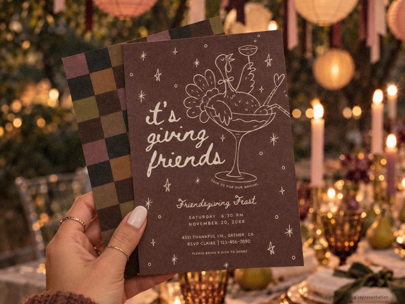 Whimsical Friendsgiving dinner invitation held in front of a warmly lit outdoor Thanksgiving tablescape with glowing candles and autumn decorations. The deep brown invitation features blush pink illustrated cocktail glass artwork, delicate stars, bows, and playful “it's giving friends” lettering. This customizable Canva fall party invitation is designed for a friends Thanksgiving dinner, girls night potluck, or autumn gathering and can be printed or sent as a digital invite.