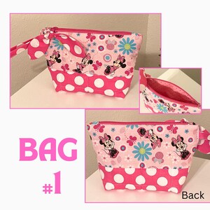 May include: Pink cosmetic bag with a Minnie Mouse print, white polka dots, and a pink zipper. The bag has a matching handle and bow. The text "BAG #1" is visible in the image.